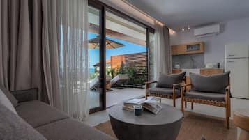 Elegant Suite Sea View | Living area | 50-inch flat-screen TV with cable channels