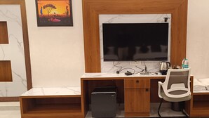 Una scrivania moderna per ufficio con un computer, una sedia e un telefono.