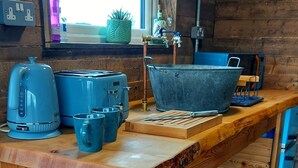 A wooden kitchen counter with various appliances and utensils. - Romantic Rural Retreat - Rustic Cabin in the Mournes with Private Hot Tub (Annalong)