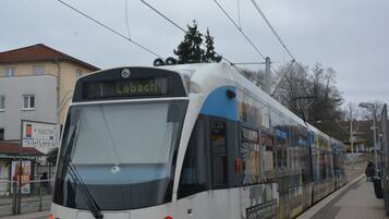 A modern tram with destination sign 'Lebenach' at a station platform.