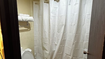 Combined shower/bathtub, towels, toilet paper