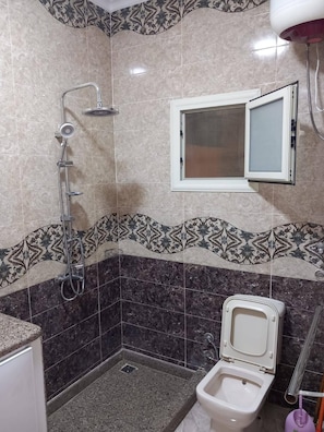 A bathroom with a shower, toilet, and a window. - 1 Bedroom Apartment Sleeping 2 People's Only (Sharm El Sheikh)
