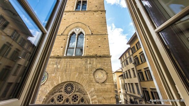 Un grand bâtiment historique doté d’arcs en plein cintre et d’une horloge.