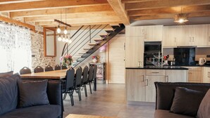 Una cucina moderna con mobili in legno, un frigorifero nero e un forno integrato.
