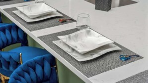A kitchen counter with a sink, a faucet, and a soap dispenser. There are two blue chairs with gold accents and a white table with a marble top. - Chic Escape · 2mi to DT · Billiards · B-Nashy (Nashville)