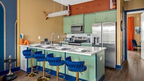 A modern kitchen with a central island, green cabinets, and stainless steel appliances. - Chic Escape · 2mi to DT · Billiards · B-Nashy (Nashville)