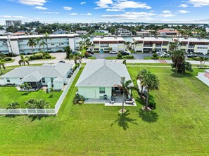 A residential area with multiple two-story houses, each with a front lawn and a driveway. - New 3-bed.2bath house in tranquil Fort Pierce. Walk to Beach and restaurants (Fort Pierce)