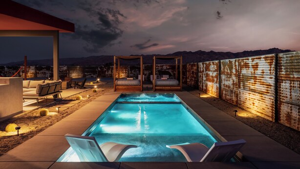 A rooftop pool with lounge chairs, a covered seating area, and a view of mountains. - Joshua Tree Oasis • Pickleball • Pool • Jacuzzi (Joshua Tree)