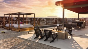 A rooftop patio with a wooden canopy, seating area, and a barbecue setup. - Joshua Tree Oasis • Pickleball • Pool • Jacuzzi (Joshua Tree)