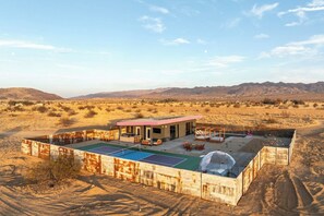 Daytime aerial of the fenced retreat with its pickleball court - Joshua Tree Dream • Pool, Pickleball, Dome, More (Joshua Tree)