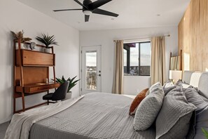 King bedroom with a ceiling fan, mid-century desk workspace and a private door - Joshua Tree Dream • Pool, Pickleball, Dome, More (Joshua Tree)