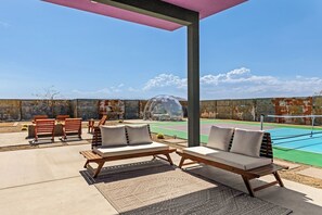 Shaded patio lounge with sofas - Joshua Tree Dream • Pool, Pickleball, Dome, More (Joshua Tree)