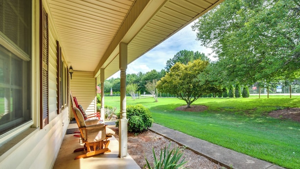 A covered porch with a view of a well-maintained lawn and trees. - West Union Home w/ Saltwater Pool on 2 Acres! (West Union)