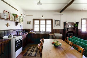 Een koffiezetapparaat/waterkoker, kookgerei, borden en bestek