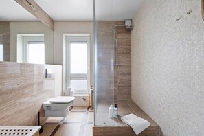 A modern bathroom with a glass shower enclosure, a toilet, and a sink. - Down Town RVK. Shopping Street Living (Reykjavík)