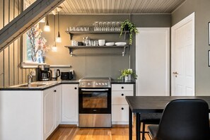 A compact kitchen with a stove, oven, and countertop.
