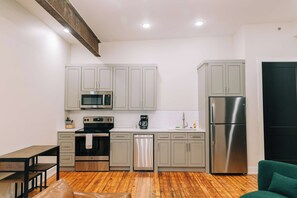A compact kitchen with a microwave, oven, dishwasher, and refrigerator. - 1 Bedroom Suite (Frankfort)