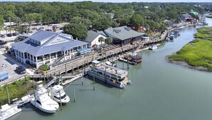 A riverside dock with a large building labeled "The Clay House" and several boats.