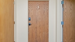 A wooden door with a number '1' sign, a door handle, and a small electronic lock. - Chic Central Nook in Great Falls (Great Falls)