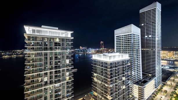 A high-rise building with multiple floors, large windows, and a modern architectural design.