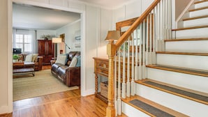 A staircase with wooden balusters and a handrail, leading to a landing with a lamp and a basket. - Spacious Taylors Home ~ 5 Mi to Dtwn Greenville! (Taylors)