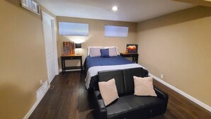 A bedroom with a bed, bedside tables, a lamp, and artwork. - Entire guest suite in Colorado Springs, Colorado (Colorado Springs)