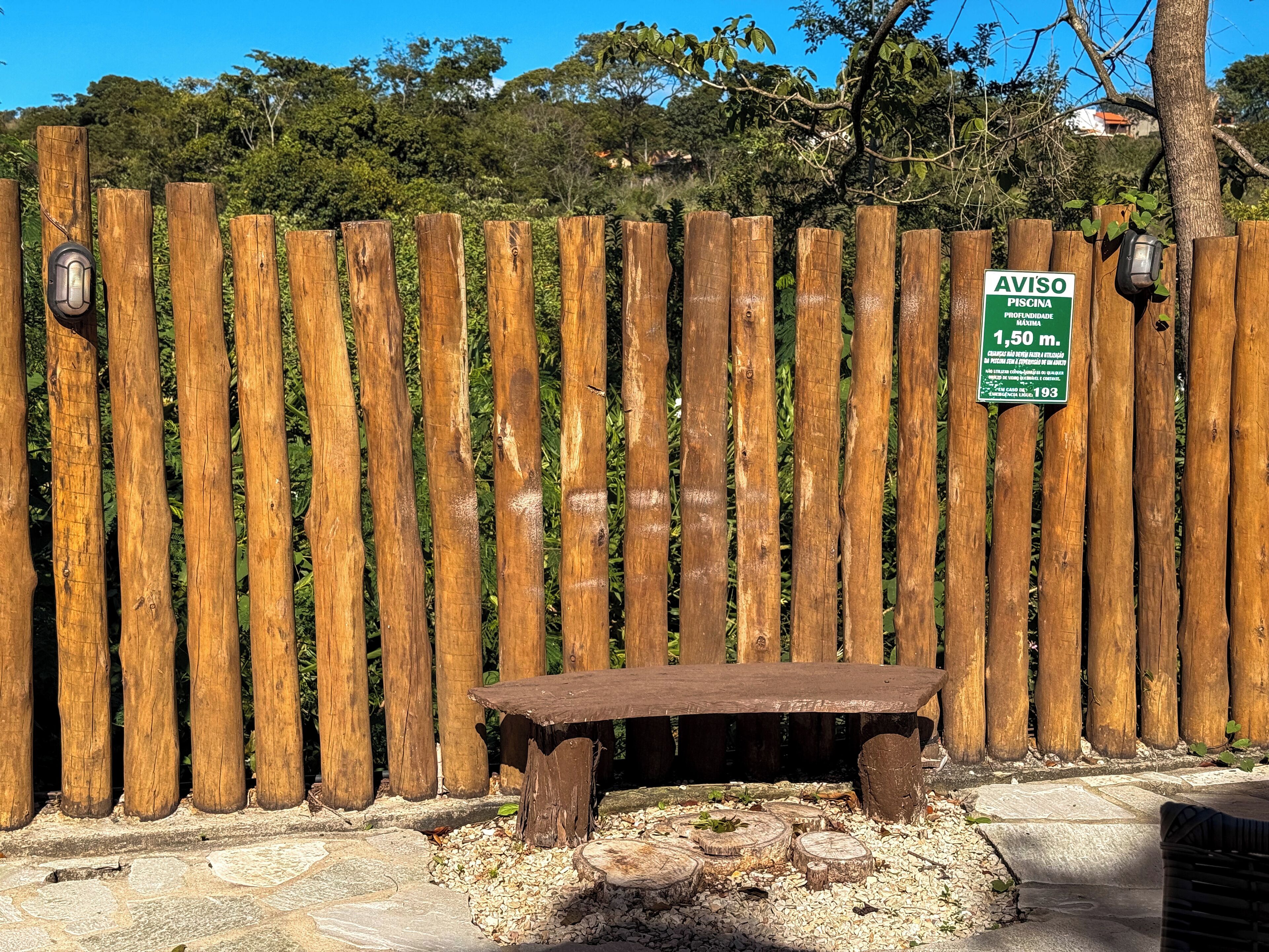 A wooden fence with a sign indicating a maximum depth of 1.5 meters.