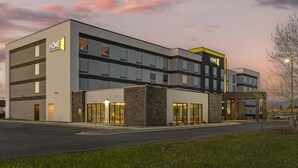 A modern hotel with a two-story structure, large windows, and a prominent 'HOME 2' sign. - Home2 Suites By Hilton Bozeman Four Corners (Bozeman)