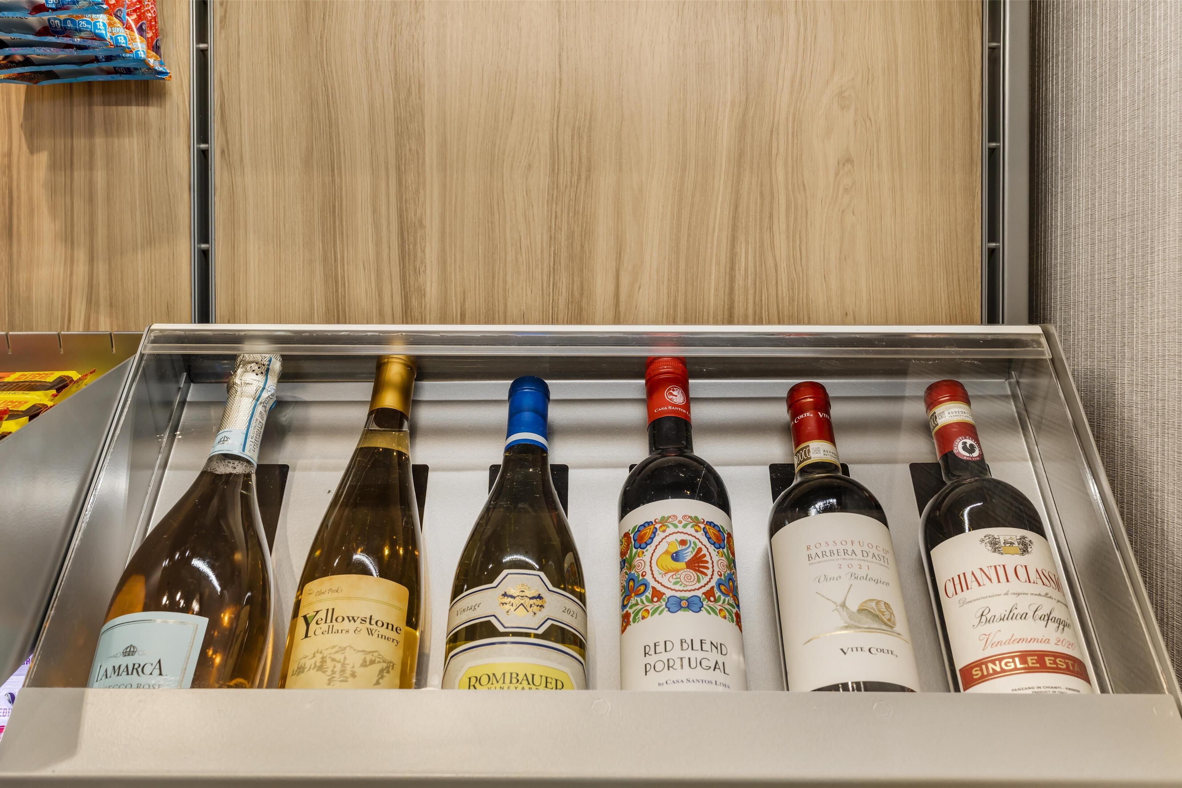 A wine cooler with six bottles of wine.