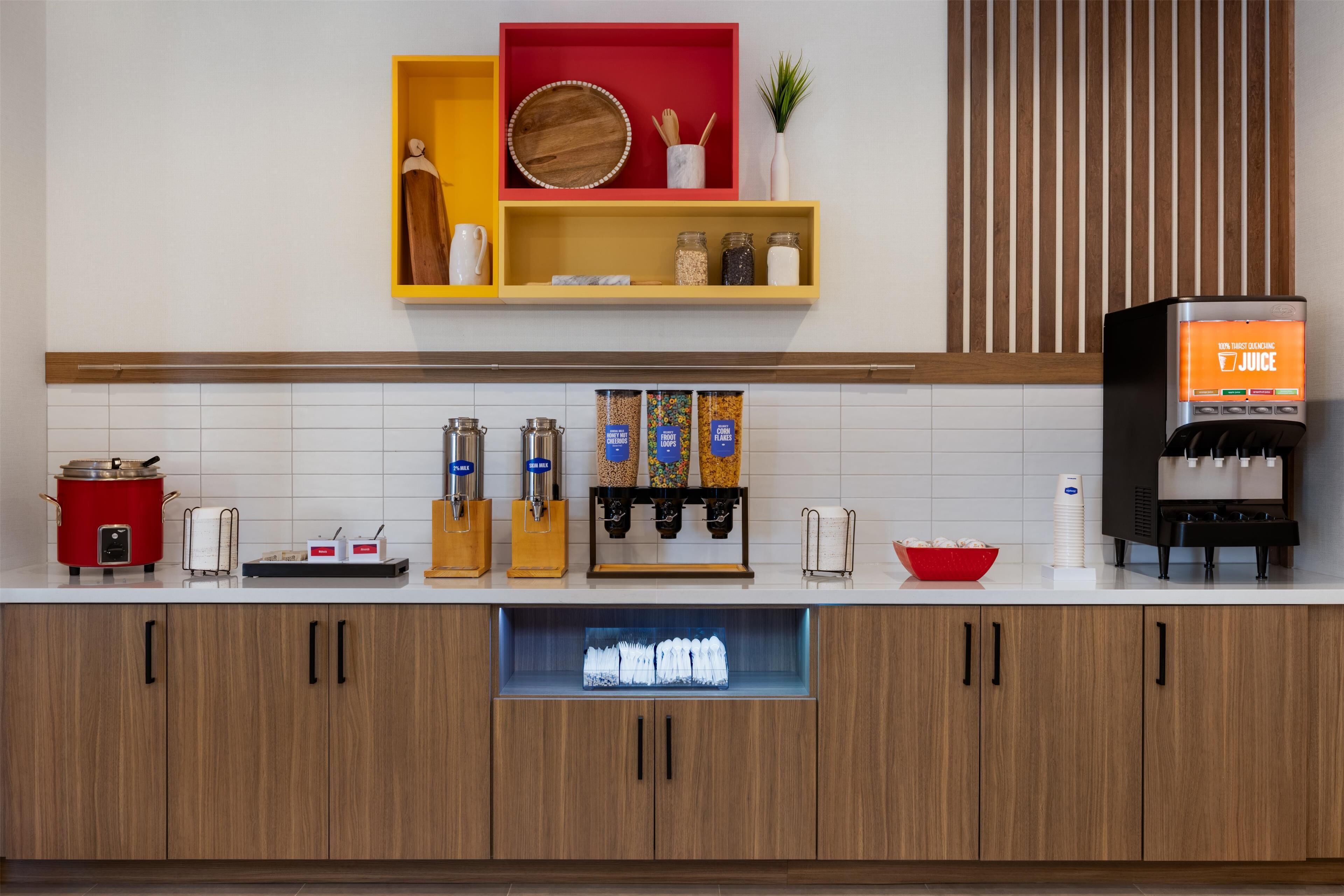 A kitchen with a coffee machine, a red slow cooker, and various kitchen utensils.