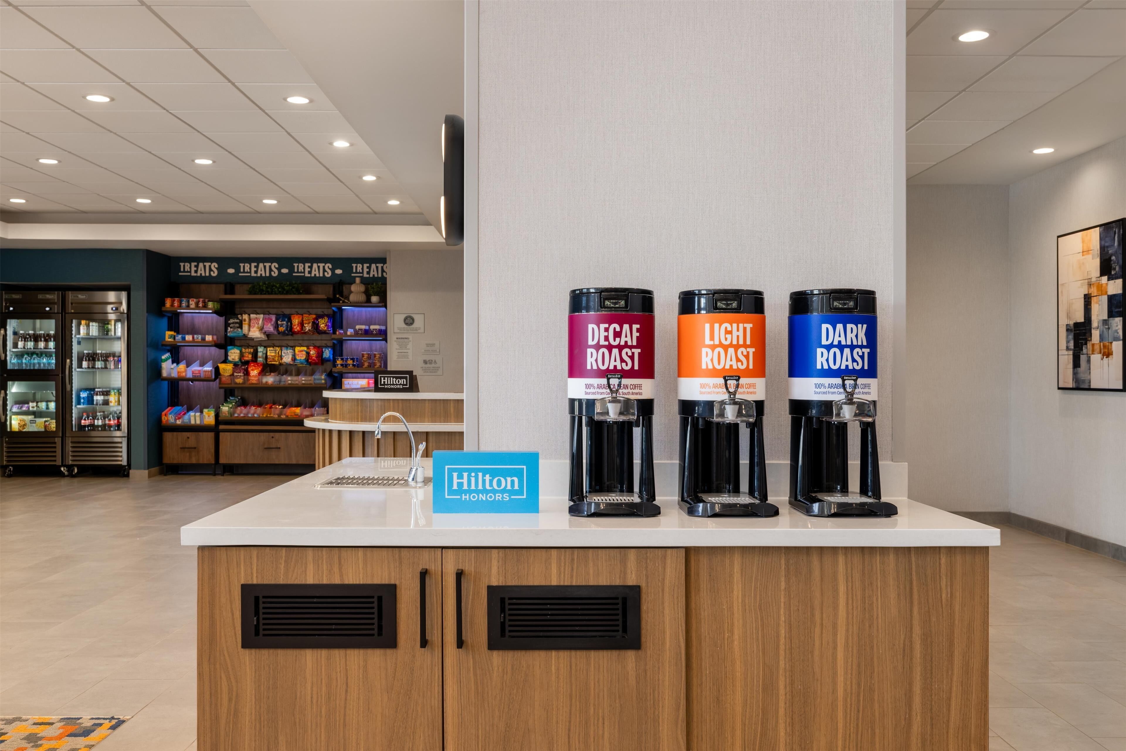 A coffee station with three coffee dispensers labeled Decaf Roast, Light Roast, and Dark Roast.