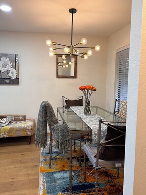 A dining area with a glass table, chairs, a chandelier, and a painting on the wall. - Hillside + View+ First Level + Pool + Remodeled!
Close to USC Keck & Attractions (Los Angeles)