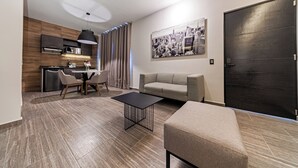 A modern living room with a dining area, a sofa, a coffee table, and a kitchen in the background. - CASA NOU (Mexico City)