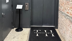An elevator with a digital display, a fire alarm, and a do not enter sign.
