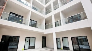 A multi-level atrium with glass railings and large windows.