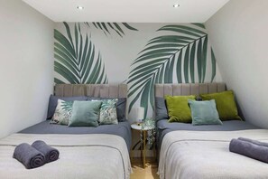 A twin bedroom with two beds, each with a pillow and a rolled towel. - City flat near Brick Lane w/ kitchen & dining (Greater London)