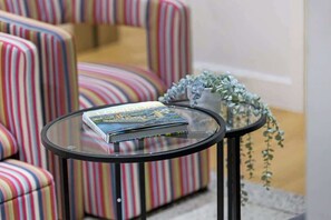 A glass-top table with a book and a small plant. - City flat near Brick Lane w/ kitchen & dining (Greater London)