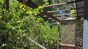 Une terrasse en bois avec une rambarde en bois et une clôture à treillis.