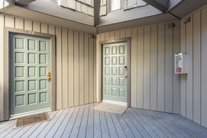 A building with two doors, each marked with a number. - Sierra Park Villas #76, Updated 1 Bedroom + 2 Lofts, 2 Bath, Sleeps 6! (Mammoth Lakes)