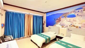 A hotel room with two beds, a large window with blue curtains, a painting of a coastal scene, and a sign on the headboard saying 'Be happy'.