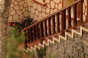 A stone staircase with a wooden railing. - Ngoi Lang CO 77 Hoang Dieu (Dalat)