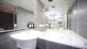 A modern bathroom with a large sink, a bathtub, and a mirror. - SongJeong coco hotel (Busan)