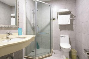 A bathroom with a glass-enclosed shower, a sink, a toilet, and a towel rack. - Cihang Hotel (Zhoushan)