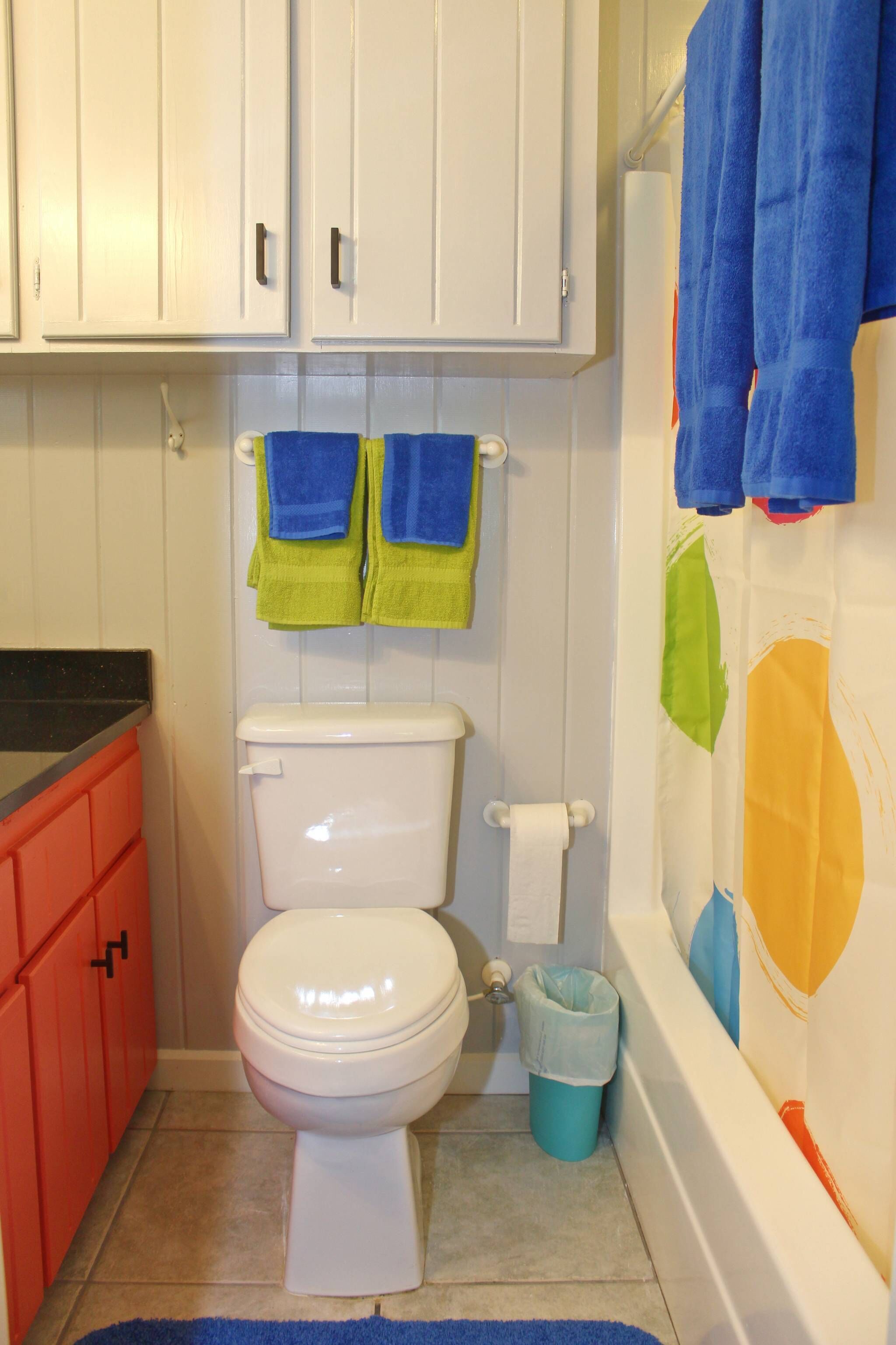 Une salle de bain avec des toilettes, une poubelle et une baignoire.