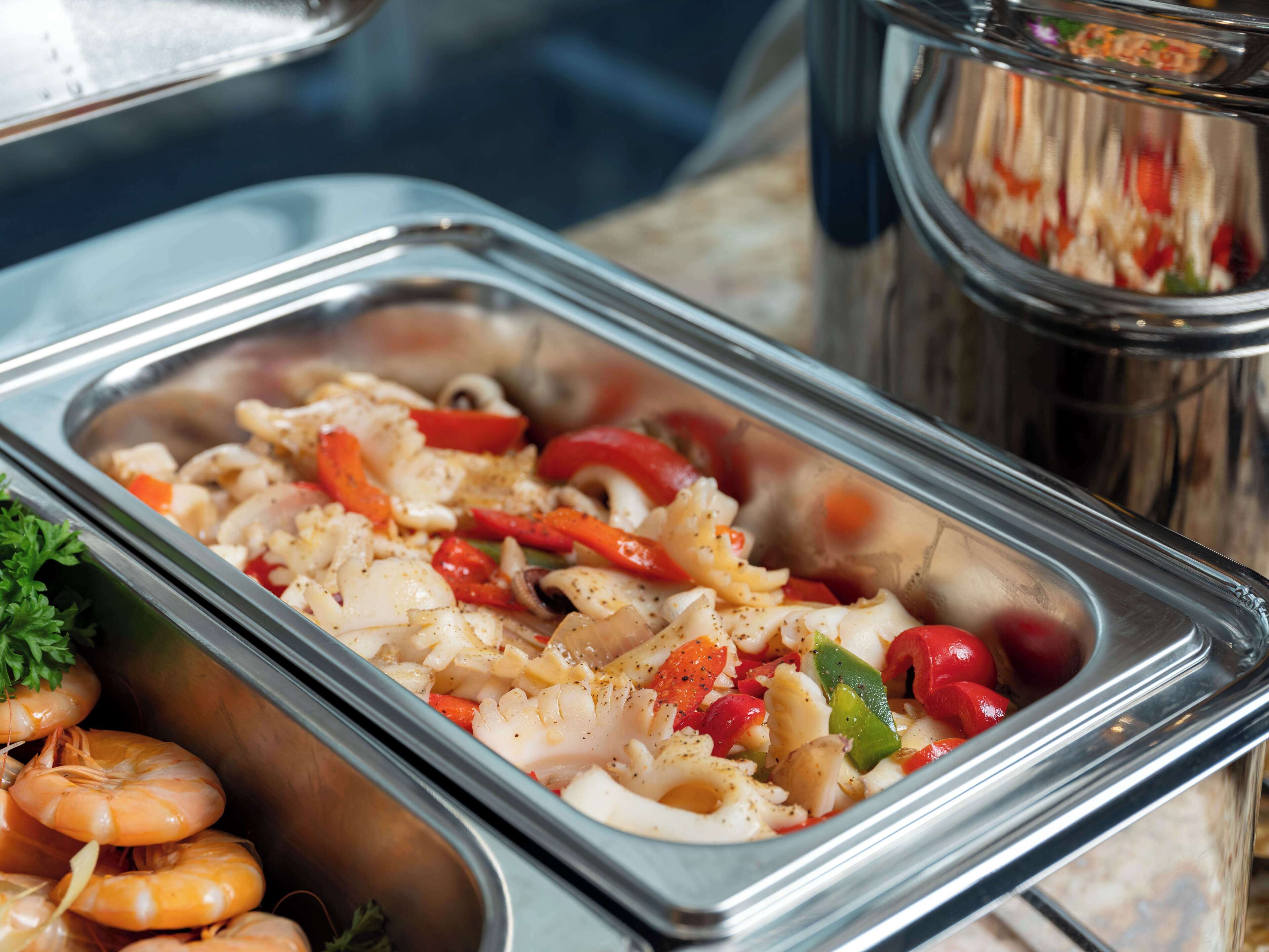 A buffet with seafood and vegetables.