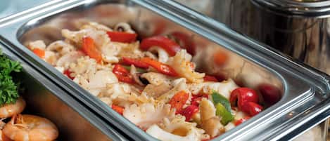 A buffet with seafood and vegetables.