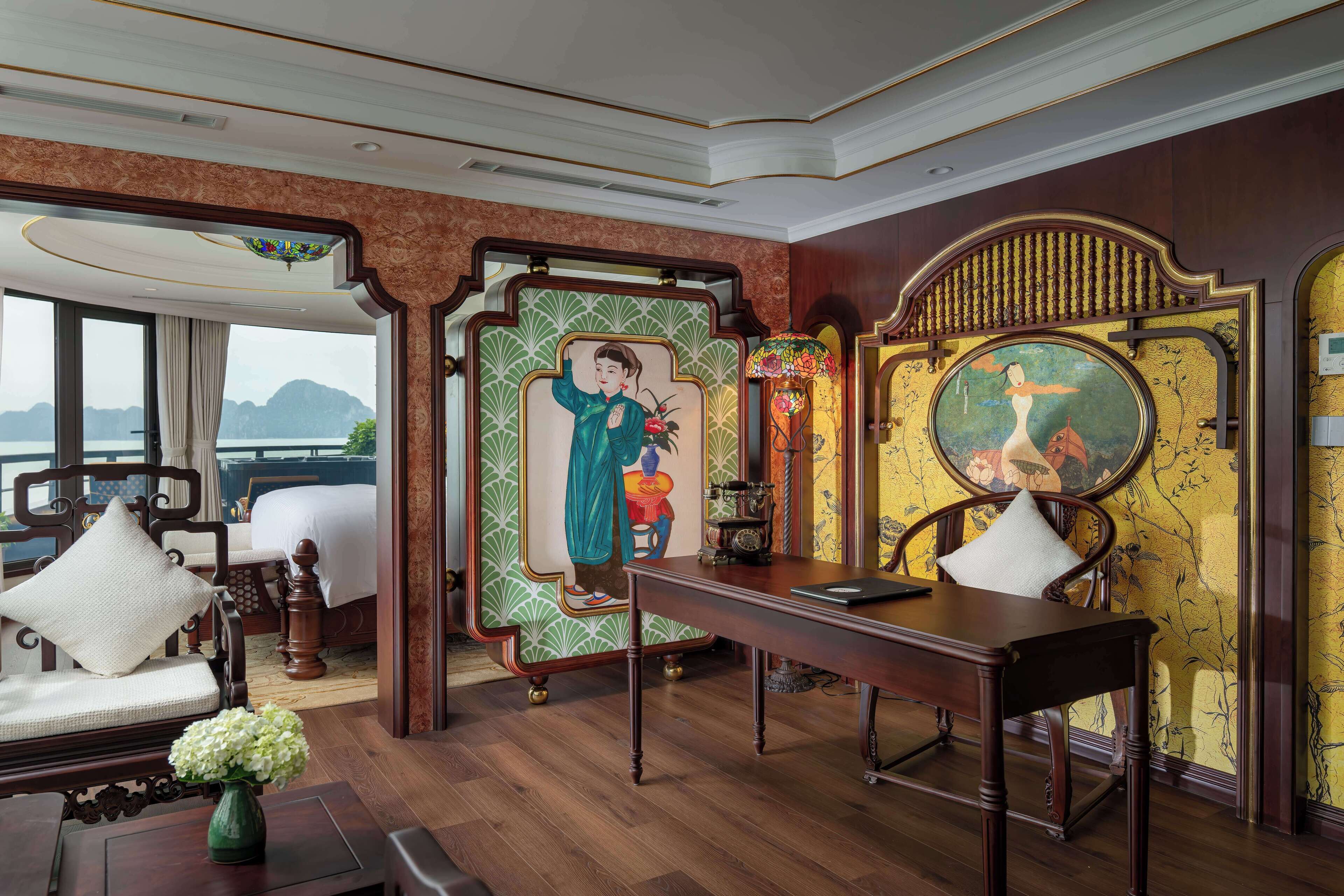 A traditional room with a bed, a desk, and a view of the sea.