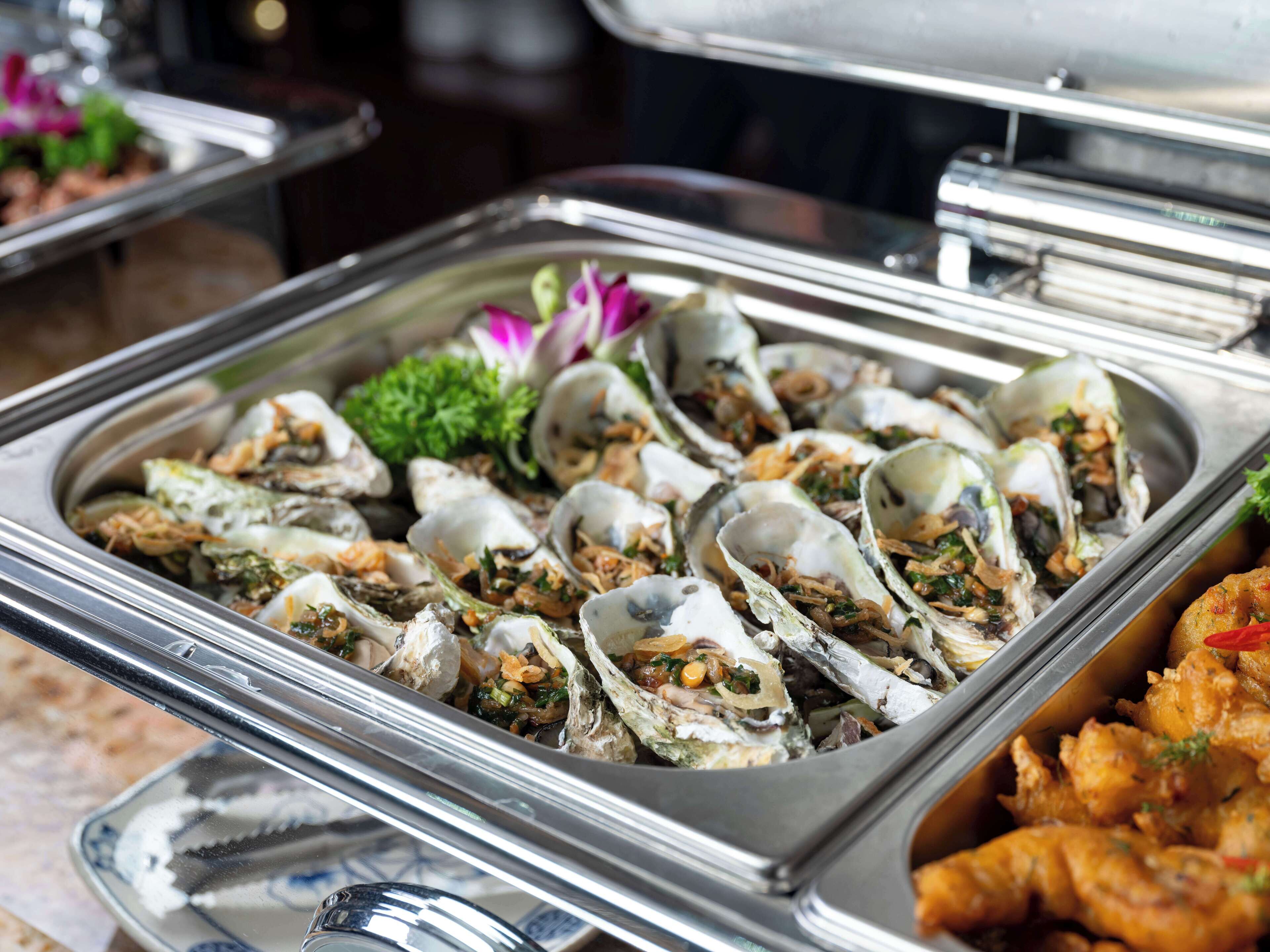 A buffet with oysters and other seafood dishes.