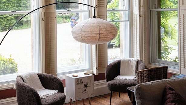 A room with large windows, a floor lamp, and two armchairs. - Gorgeous 3BD in Oxfordshire Countryside (Bicester)