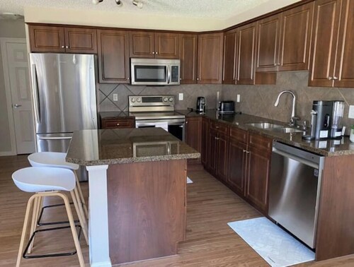 Entire Home in Edmonton South close to Airport with fenced private yard & deck